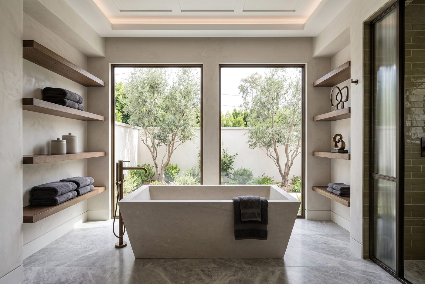 Luxury bathroom with stone soaking tub and garden view